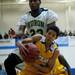 Huron sophomore Brian Walker jumps for a loose ball and fouls Ypsilanti junior Janeau Joubert in the game on Friday, March 8. Daniel Brenner I AnnArbor.com